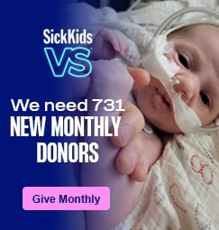 A baby that is intubated and laying in a bed. SickKids VS. We need 731 new monthly donors. Give monthly.