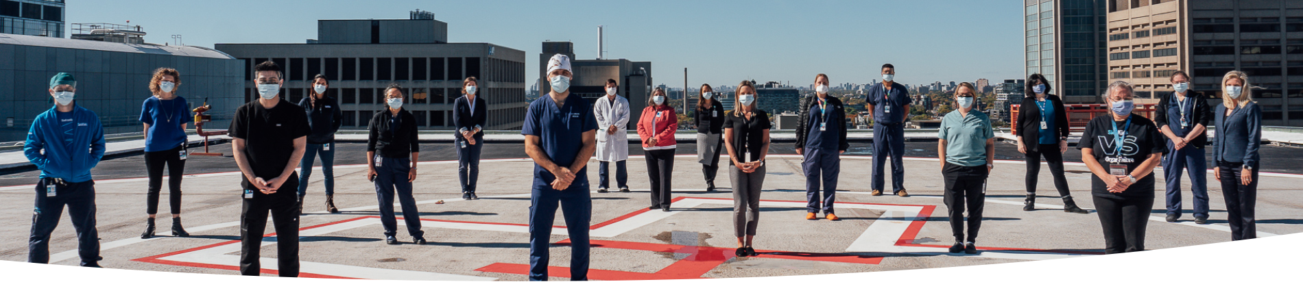 SickKids hospital workers standing on top of the emergency helicopter pad.
