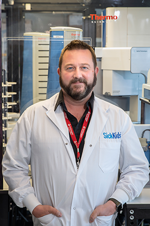 Facility Manager Chris Fladd, standing  in the SPARC Drug Discovery Facility at SickKids