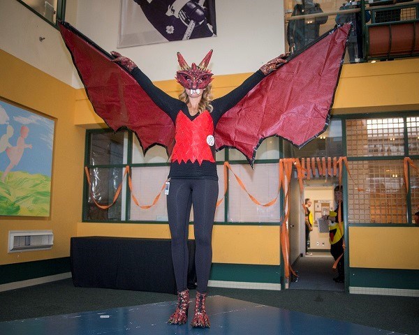 A woman dressed as a red and black dragon.