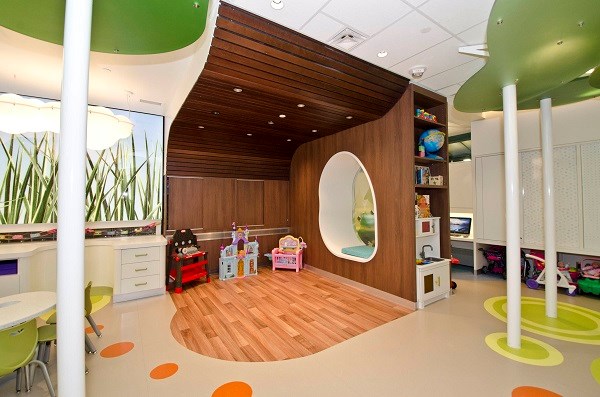A play corner with wood floor and walls.