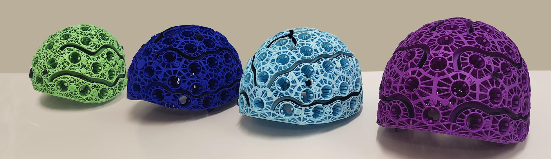Four colourful helmets for OPM powered MRI.