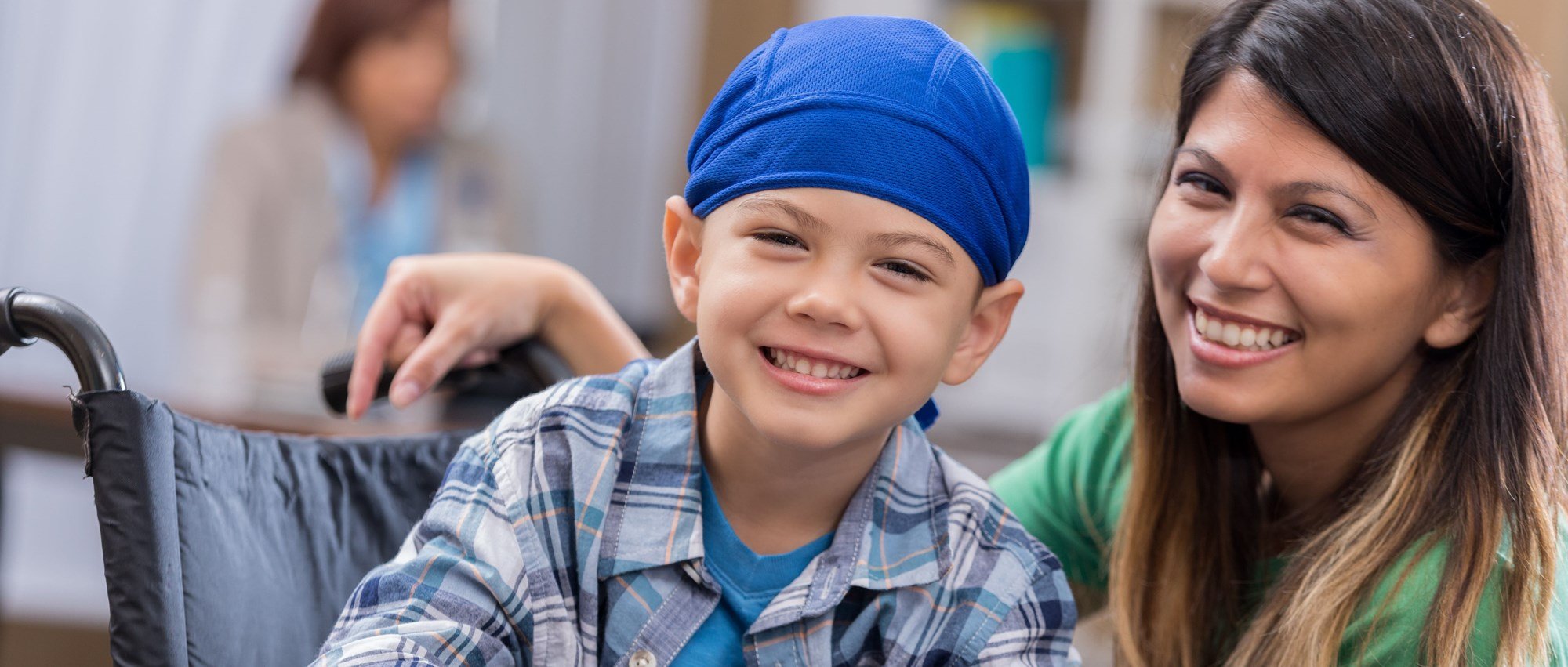 smiling young boy in the hospital with his caregiver