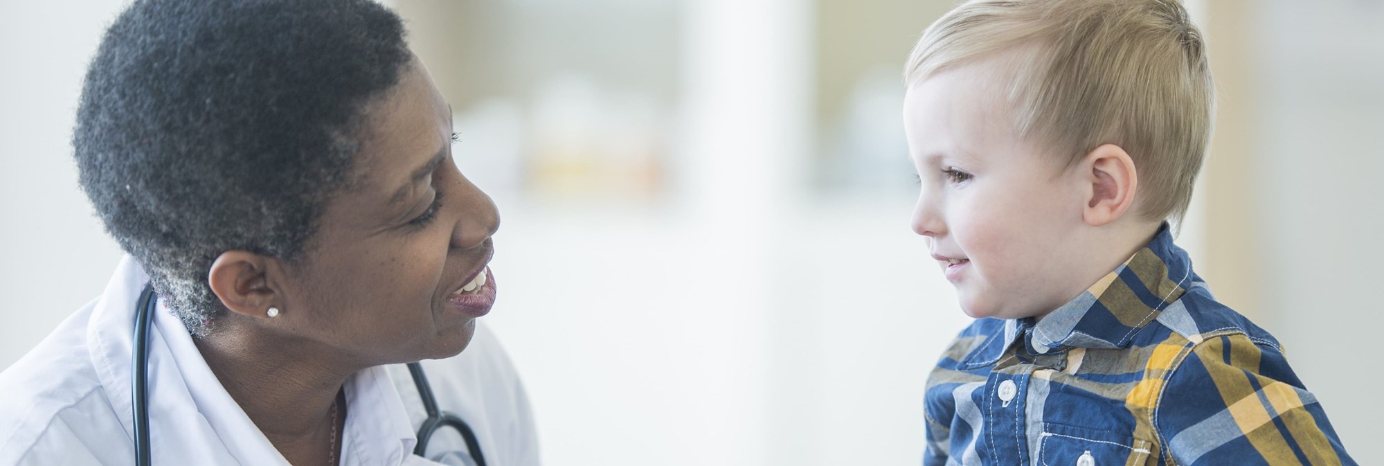 profile view of doctor and young patient looking at each other