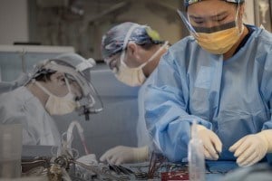 2 surgeons and 1 nurse in an operating room