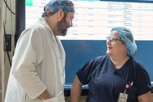 A surgeon is talking with a nurse