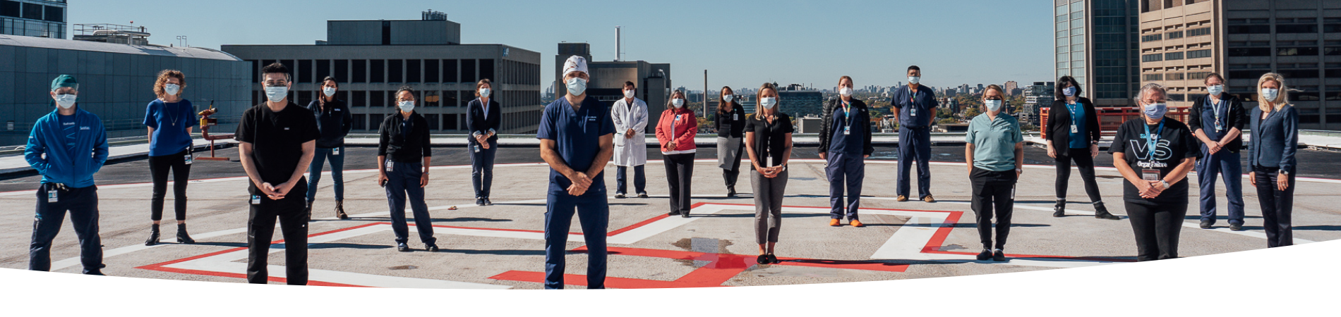 SickKids hospital workers standing on top of the emergency helicopter pad.