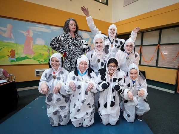 Adults dressed as dalmatians and one dressed as Disney character Cruella de Ville.