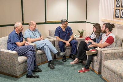 A group of people sit together in conversation.