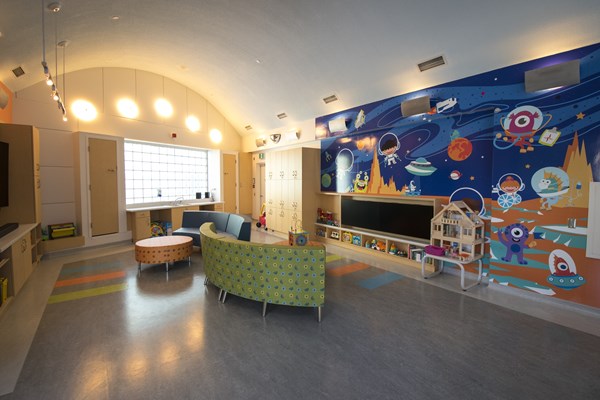 The Samsung Space, with a wall mural, couches and toys.