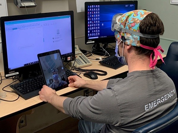 Daniel Rosenfield infront of a screen testing a new virtual consult system