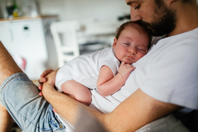 A man holding a newborn son.