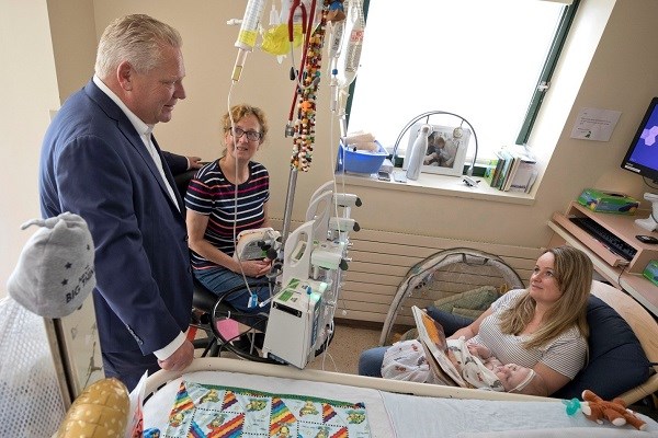 Doug Ford speaks with patient Aaron's family