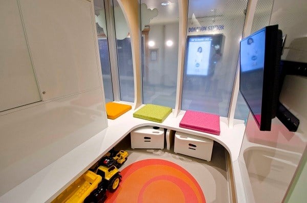 Gaming corner with a bench seat and mounted television.