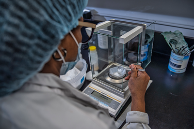 Dr. Glenda Courtney-Martin measures nutrients on a scale in the SickKids metabolic kitchen.