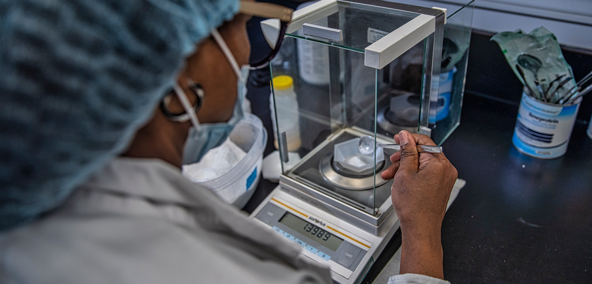 Dr. Glenda Courtney-Martin measures nutrients on a scale in the SickKids metabolic kitchen.