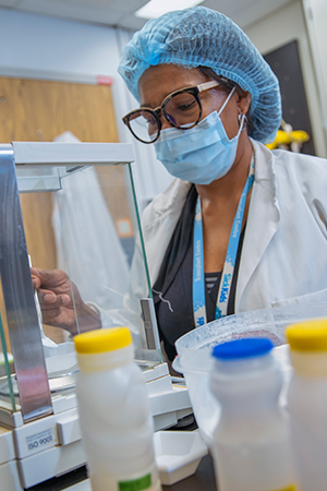 Dr. Glenda Courtney-Martin measures nutrients at a bench in the SickKids metabolic kitche.