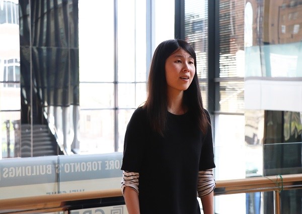 Woman sings in an atrium.