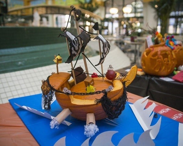 Pumpkin carved and decorated to look like a pirate ship.