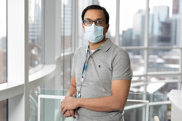 Physician pictured in SickKids research building wearing a mask.