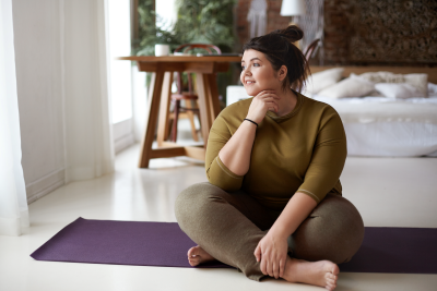 A woman sitting on a yoga mat