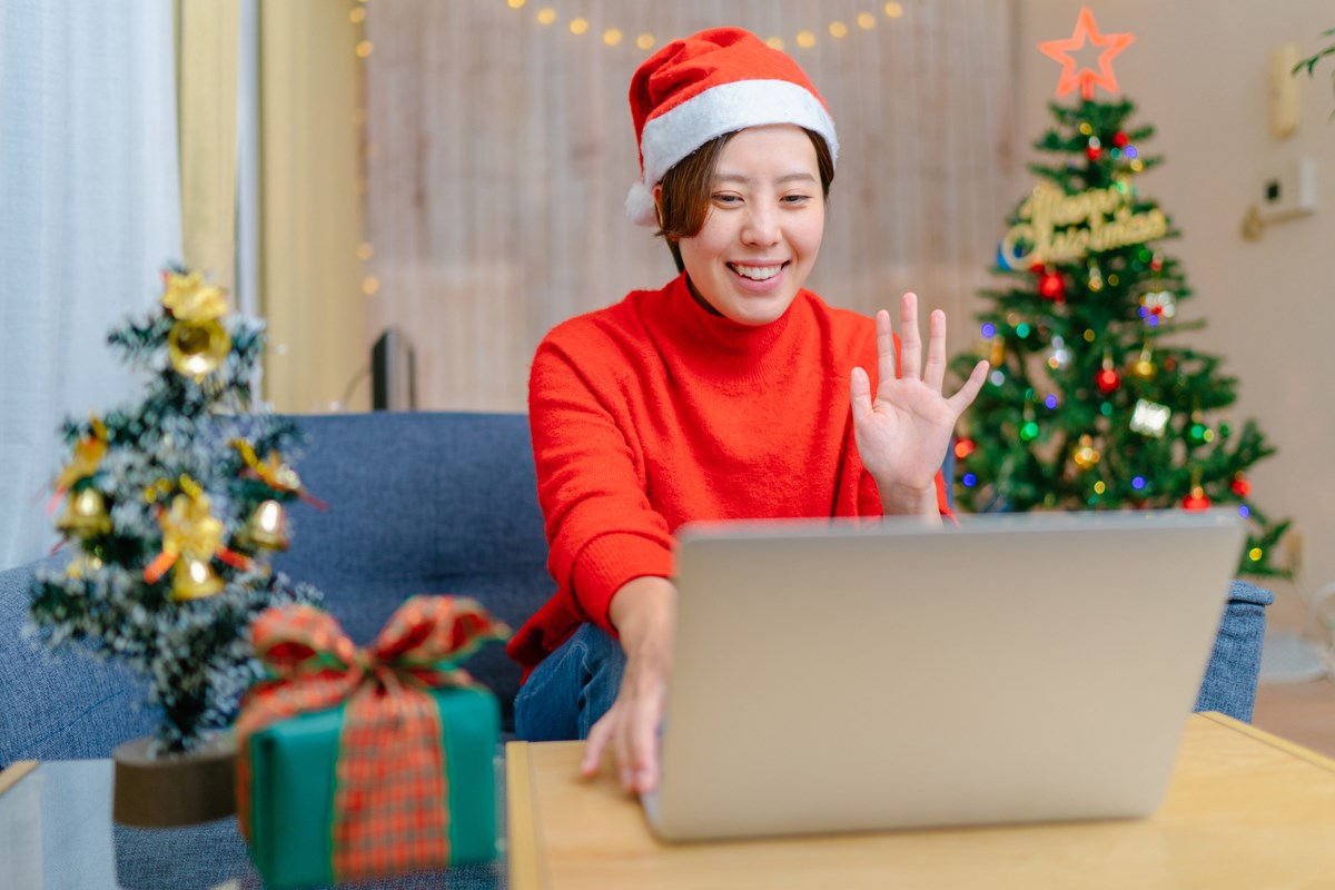 Woman on a laptop with holiday decorations