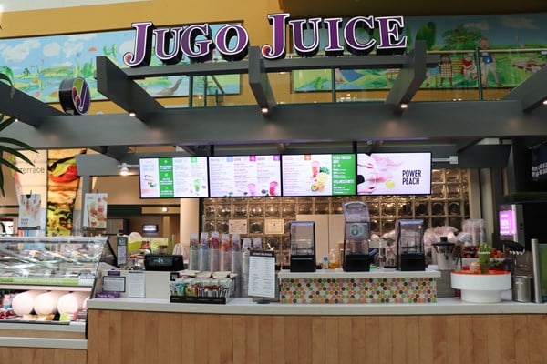 Jugo Juice stand facing the counter and menu boards