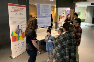 SickKids staff speaking to children and families at an IBD Family Night event.