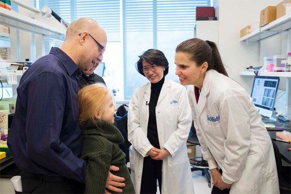 Group of people stand together in a lab.