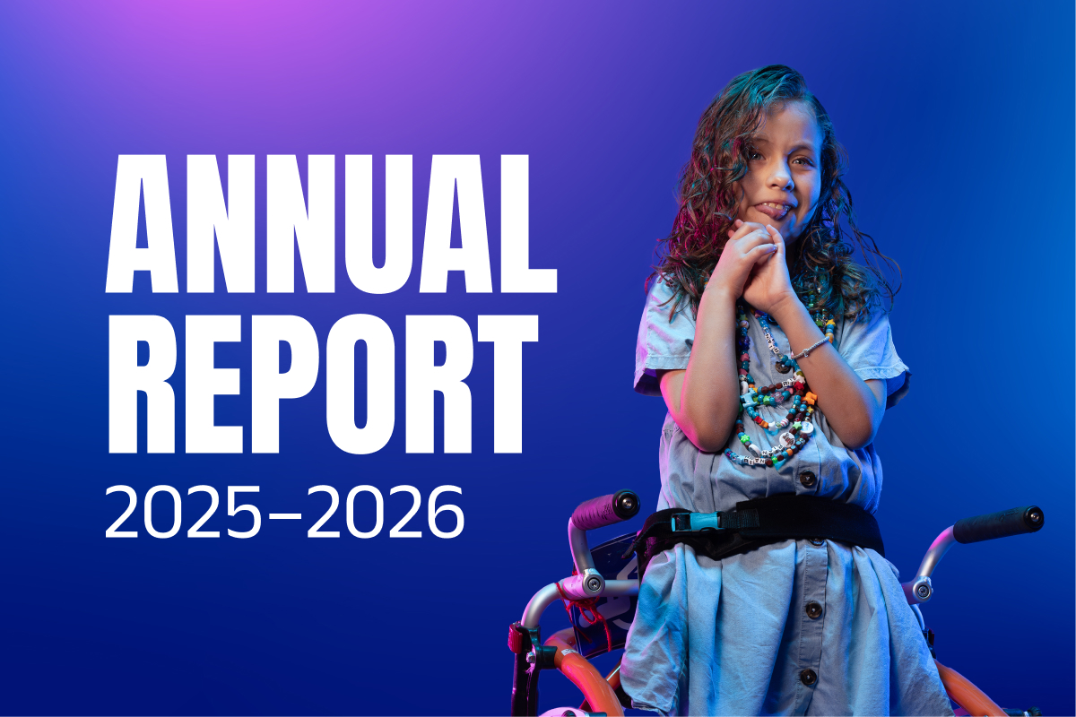 Cover of the 2025-2026 annual report showing a person using a wheelchair against a blue and purple background. Large white text reads “Annual Report 2025-2026.”