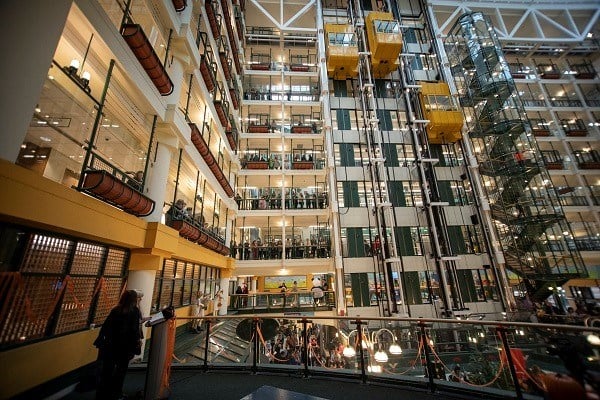 An interior view of the SickKids atrium. You can see people crowded along the walkways on many floors.