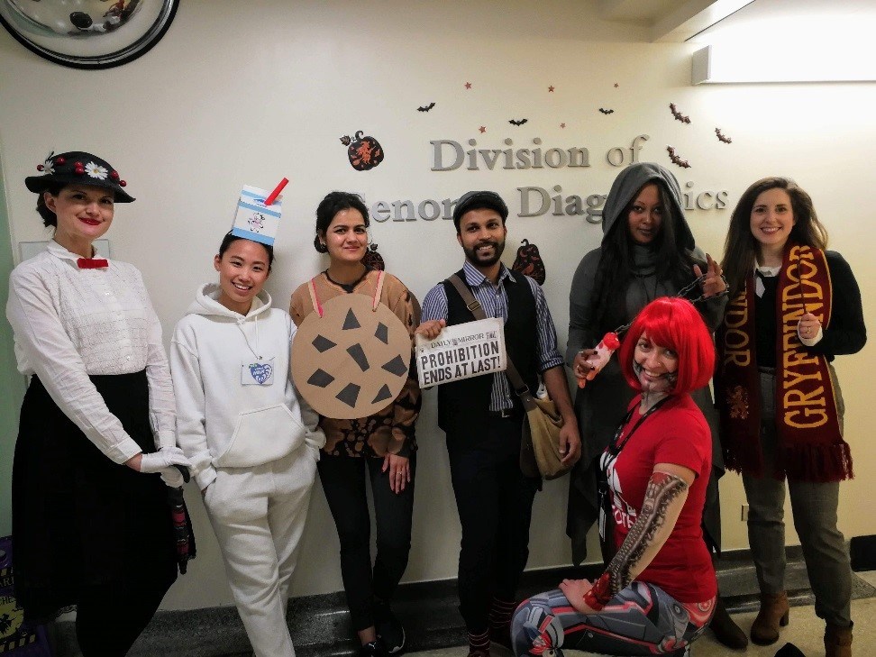 Group of adults in a variety of costumes.