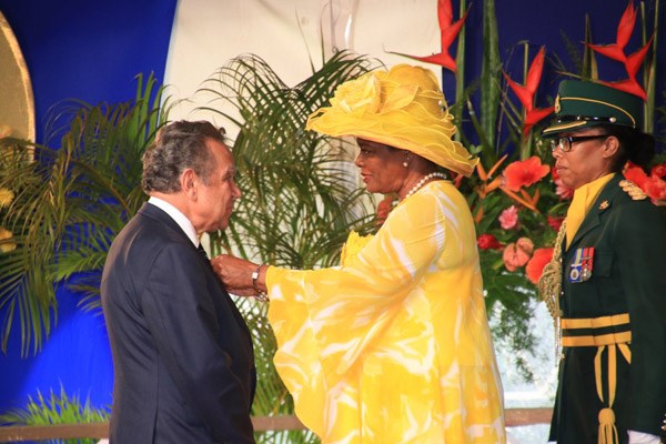 Woman places pin on a man's lapel.