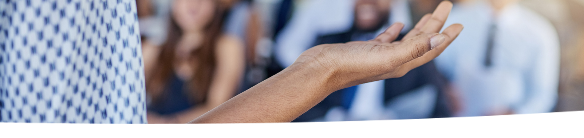 A woman stands in front of an audience.