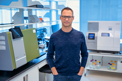 Greg Wasney stands surrounding by research instruments in the SBC Facility.