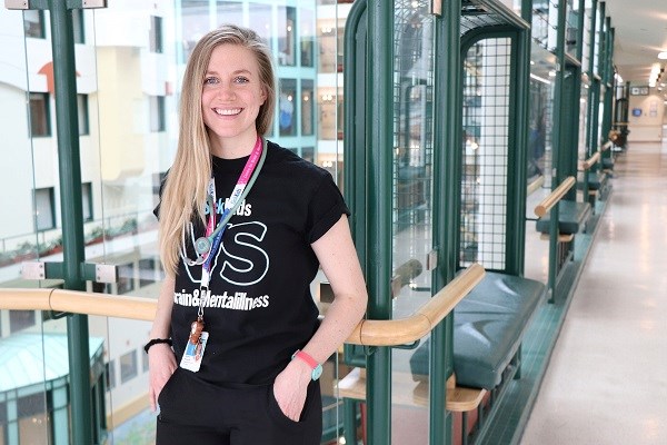 Alysha smiles in the SickKids atrium