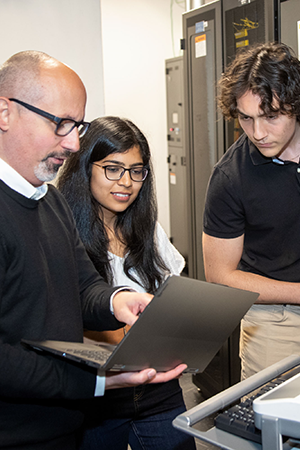 Staff at SickKids High Performance Computing working with servers.