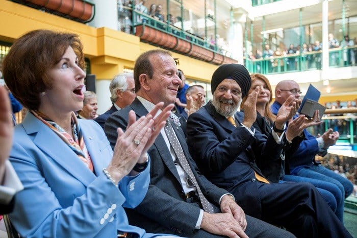 Katie Taylor, Sabi Marwah and Peter Gilgan sit next to each other in chairs smiling