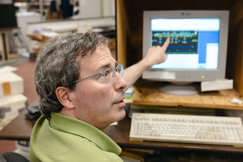 Lewis Kay pointing at computer screen