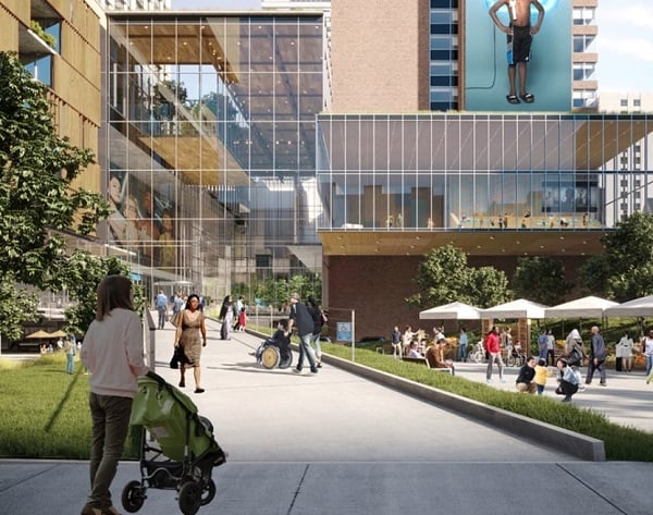 Architectural rendering of the ground level exterior of a modern glass paneled building with a sign that reads SickKids. The entrance is lined with trees and pedestrians walking about.