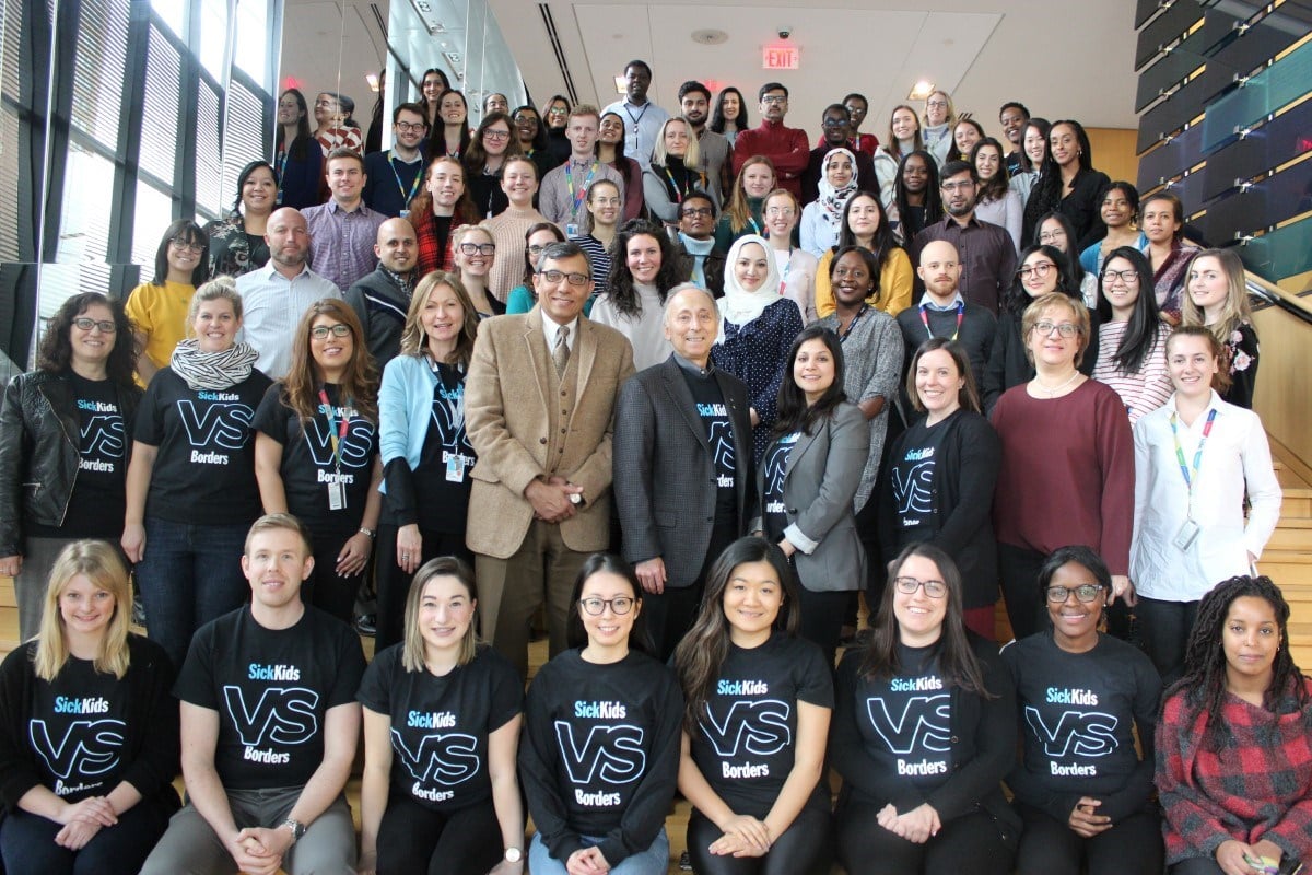 Group of approximately 50 staff pose for a photo