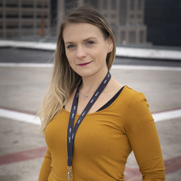 SickKids employee Katie stands on a helipad