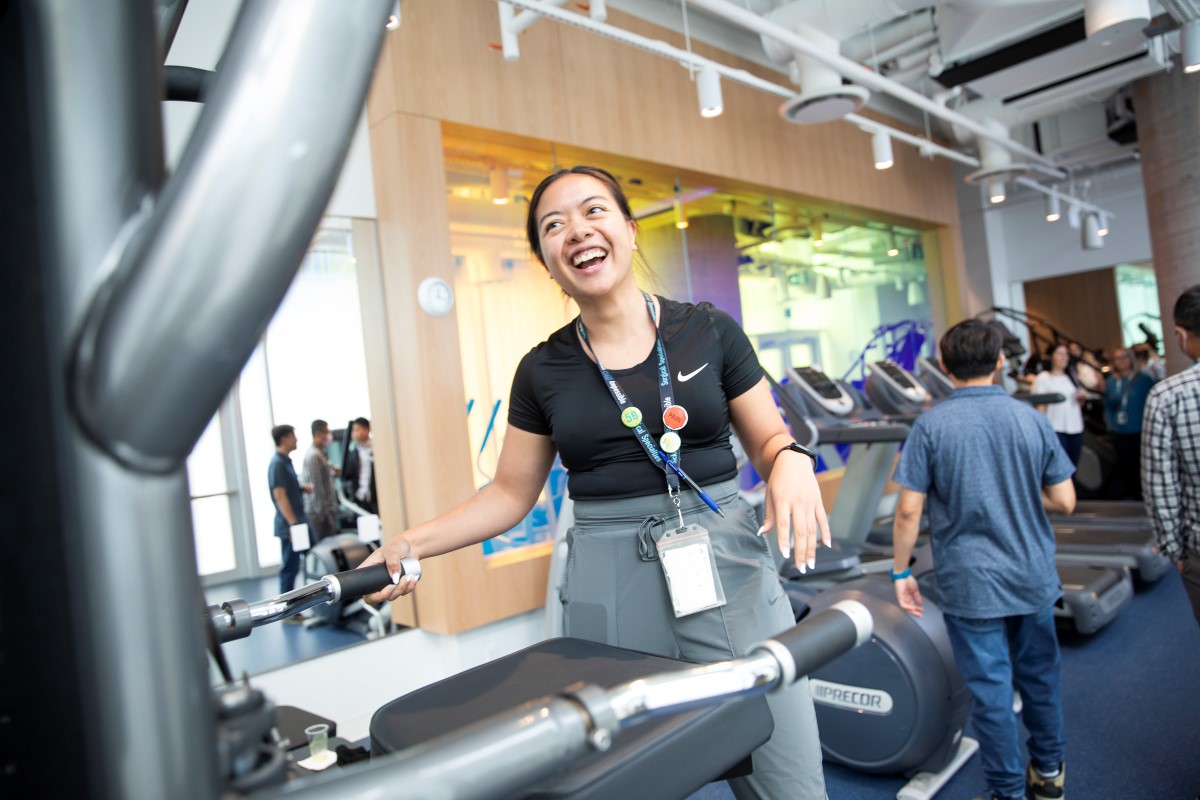 Woman demonstrating exercise equipment.