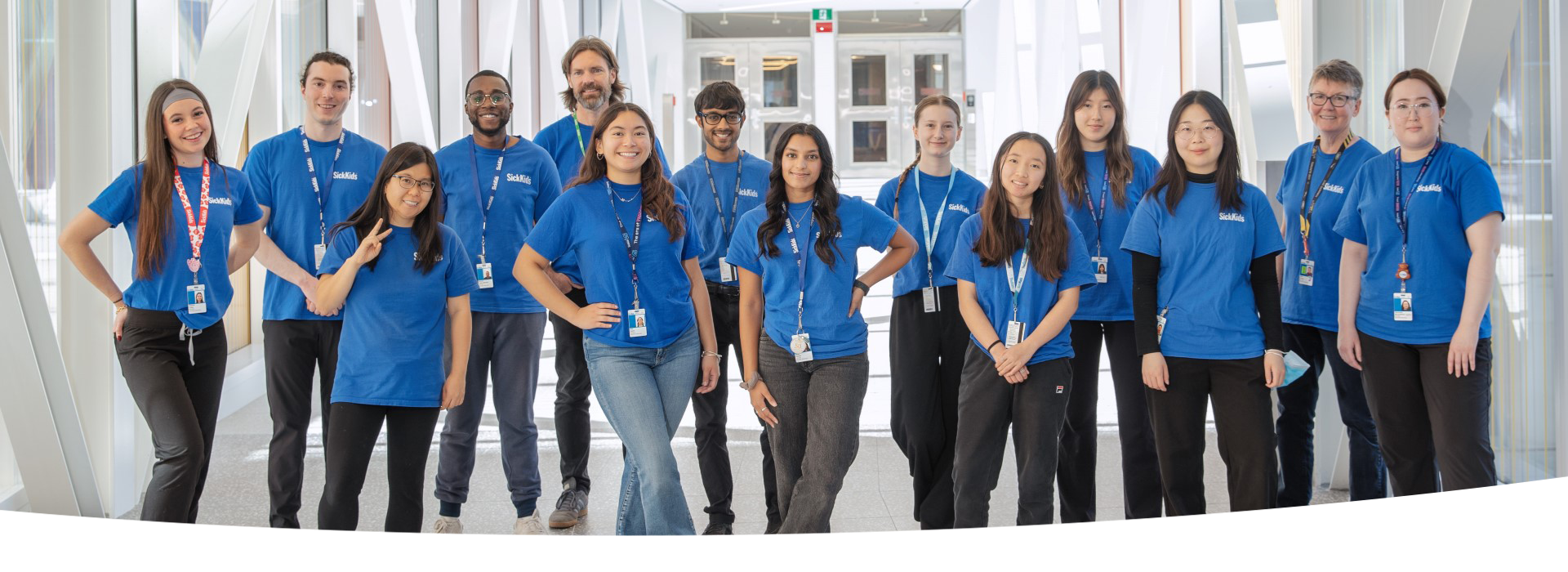 Group of people wearing blue SickKids volunteer t-shirts.