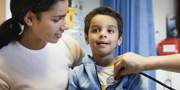 Boy getting his heartbeat checked by a doctor