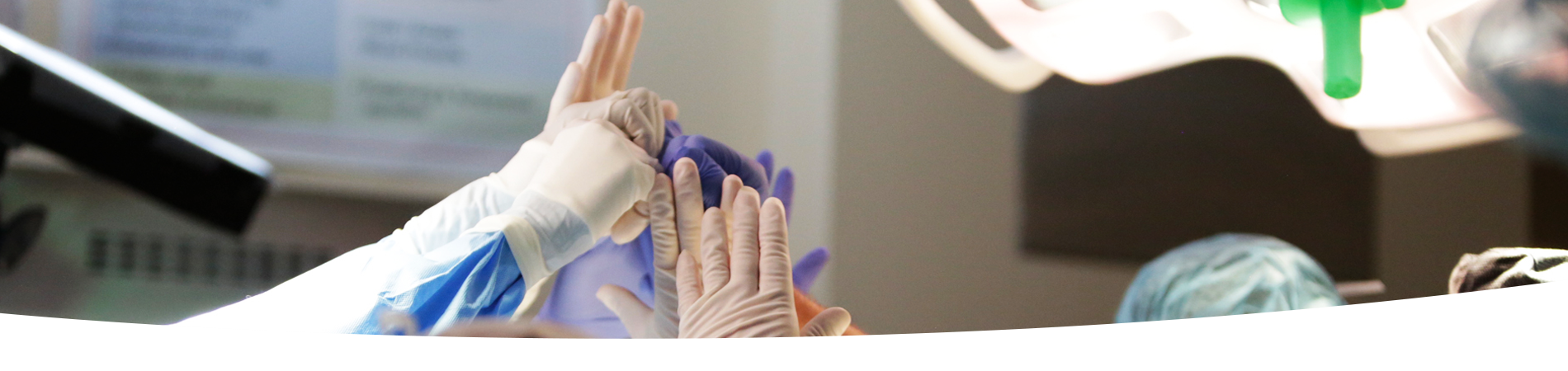 Close up of surgeon hands high fiving during operation