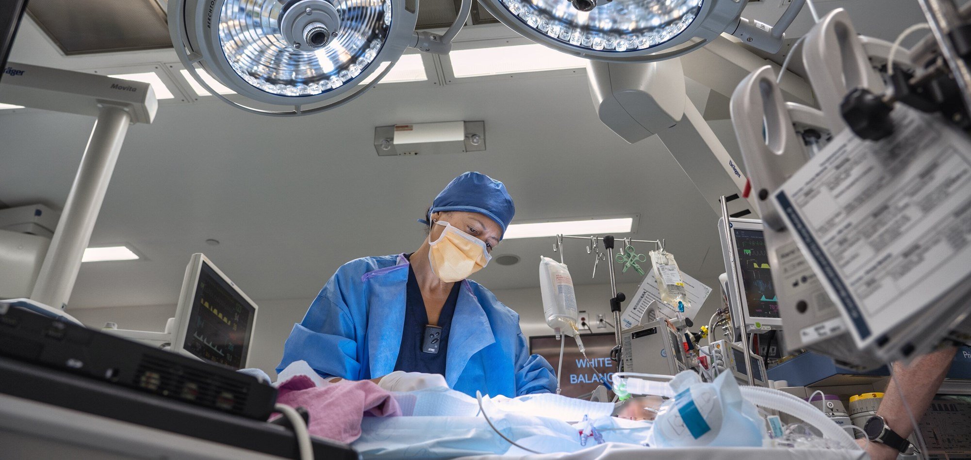 View of an operating room and doctor in action with surgical lights above