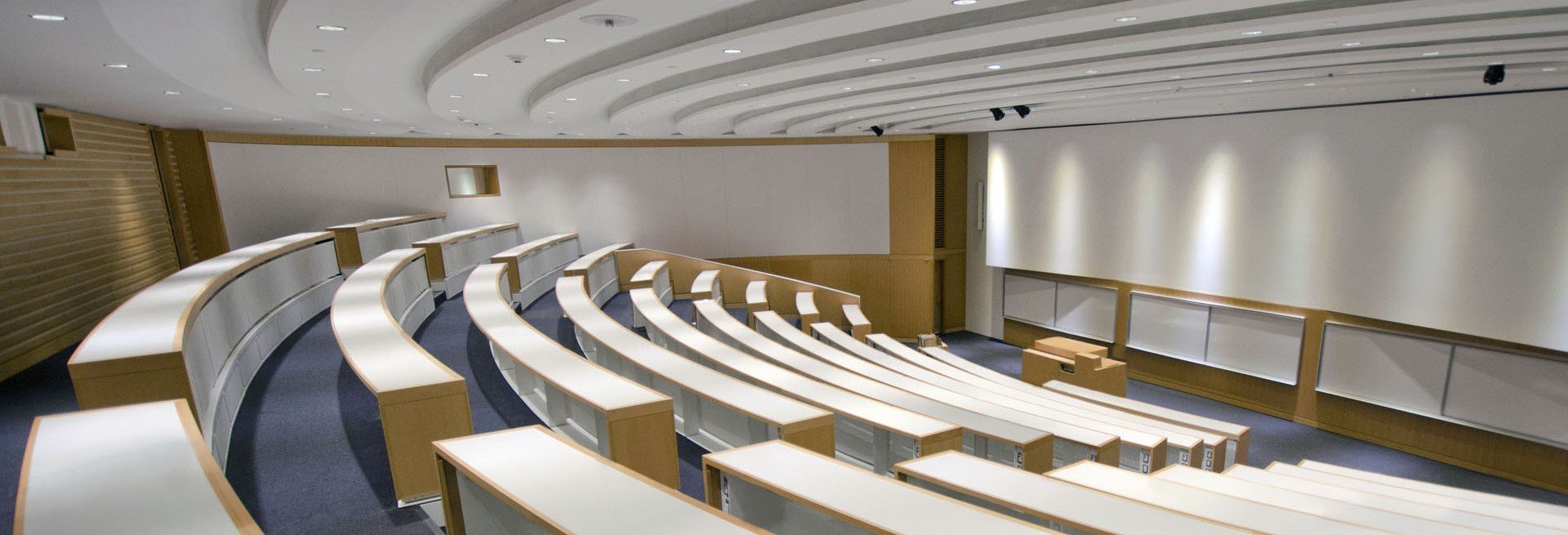 Empty lecture hall of 15 rows and a speaking podium