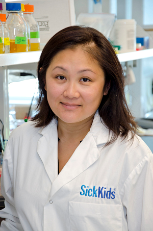 Scientist wearing a lab coat in a lab setting.