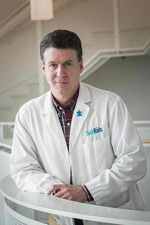 Stephen Scherer in a white lab coat